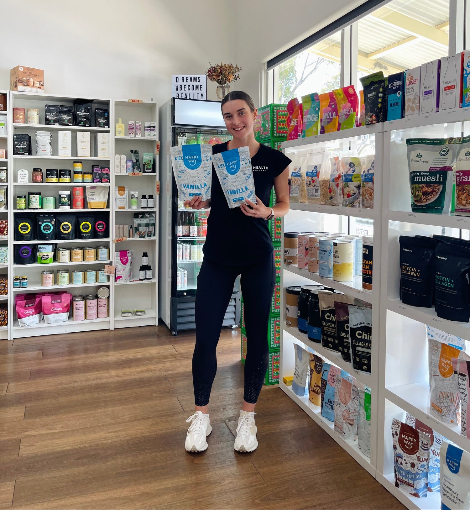 Woman in health shop holding protein