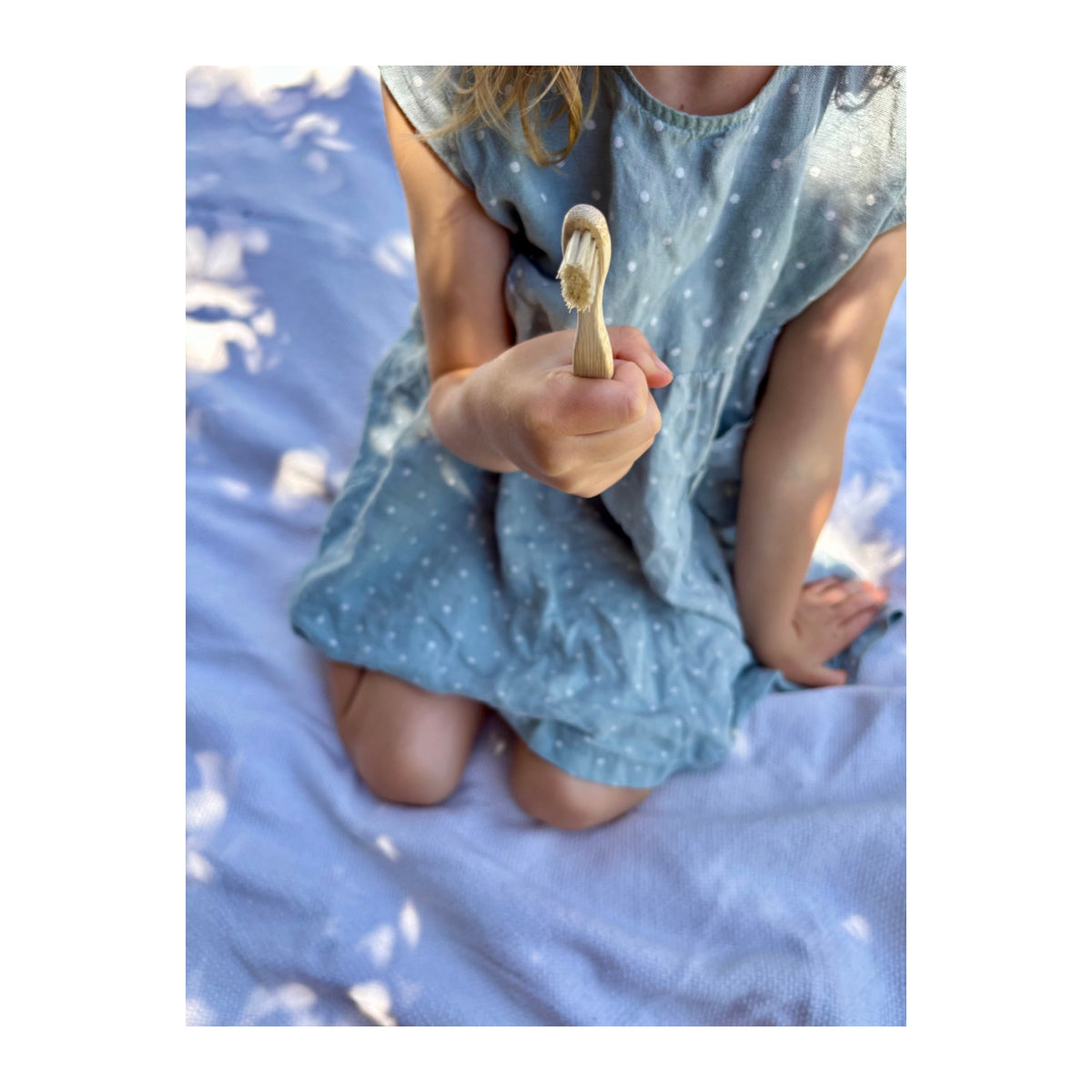 Child brushing with a Natural Health Co bamboo toothbrush